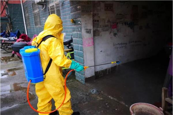 衛(wèi)生人員對市場進(jìn)行消毒